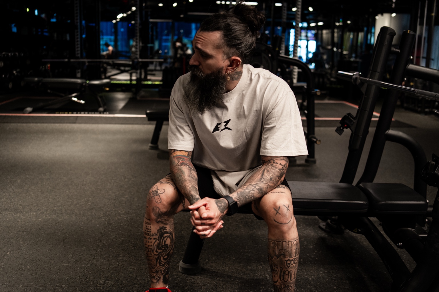 Jotik Serje seated in a gym wearing a white EZ shirt